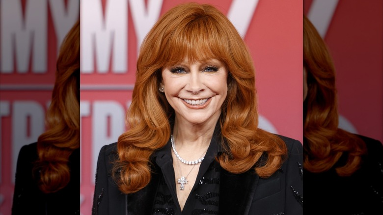 ﻿Reba McEntire, con un maquillaje monocromático que no le queda bien y sonriendo en la 60ª edición de los Premios de la Academia de Música Country