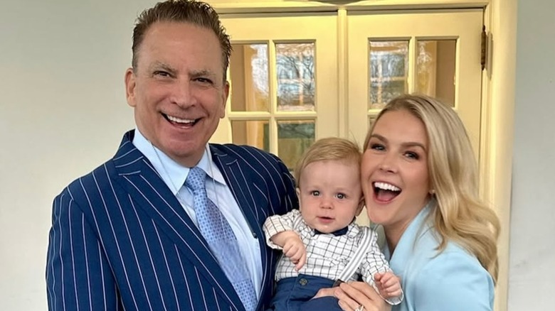 Karoline Leavitt y su marido sonriendo mientras sostienen a su hijo