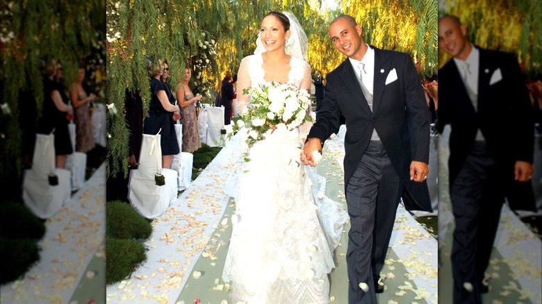 Jennifer López sonriendo y sosteniendo un ramo en su boda de 2001 con Cris Judd.