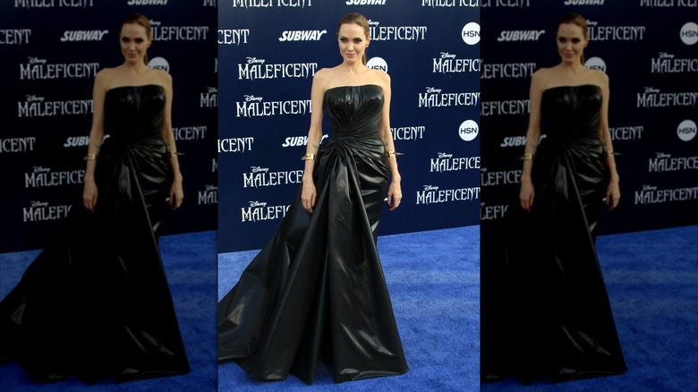 Angelina Jolie sonríe con un vestido palabra de honor de cuero.