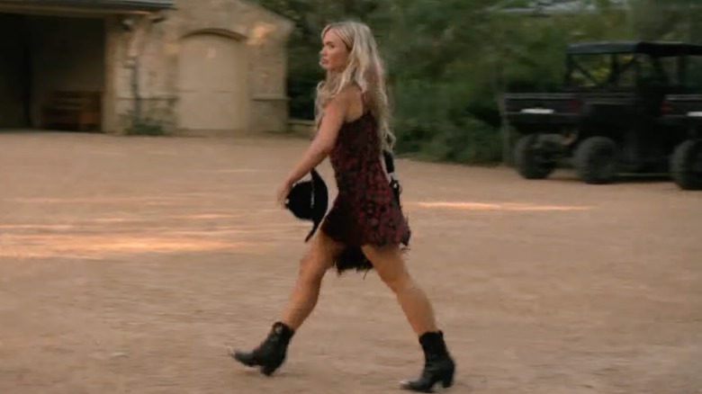 Oreana Jackson pasea luciendo un minivestido de flores y botas cowboy en una escena de 