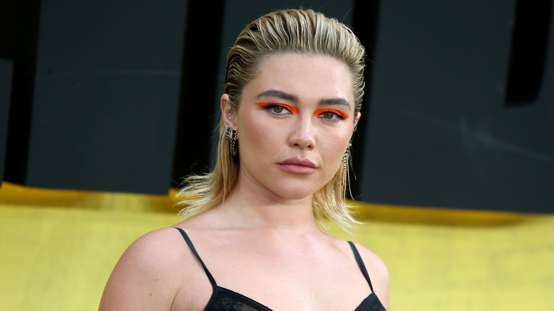 Florence Pugh con un look mojado peinado hacia atrás y un forro gráfico