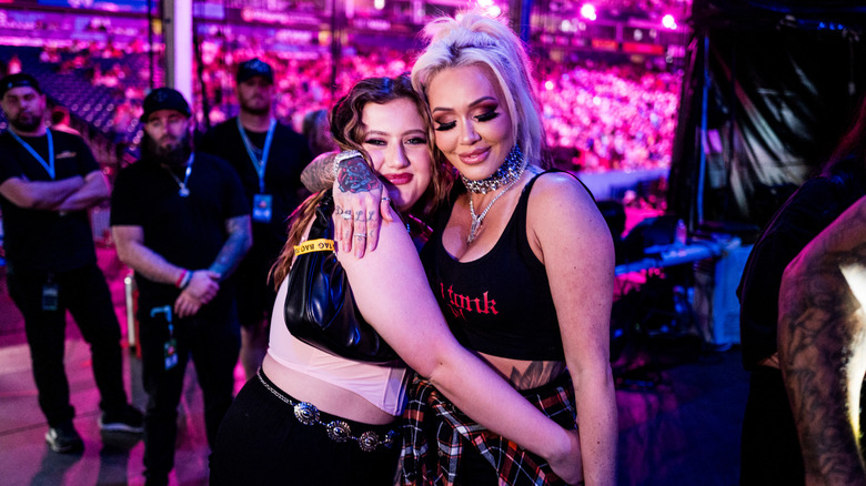 Bailee Ann DeFord y Bunnie Xo compartiendo un abrazo en un concierto
