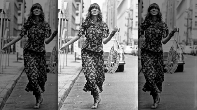 Carly Simon sonríe en la calle luciendo un conjunto floral de dos piezas
