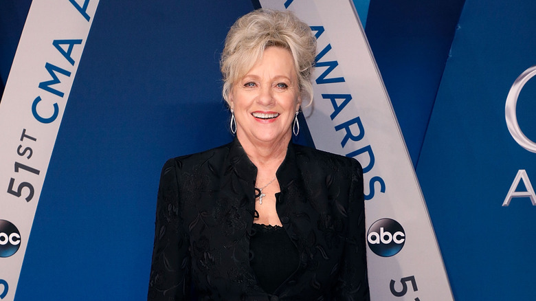 Connie Smith fotografiada en 2017 con el pelo recogido y una chaqueta negra.