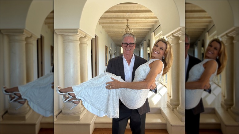 John Donaldson sostiene a Vanna White, que luce un vestido de novia blanco con cuello halter